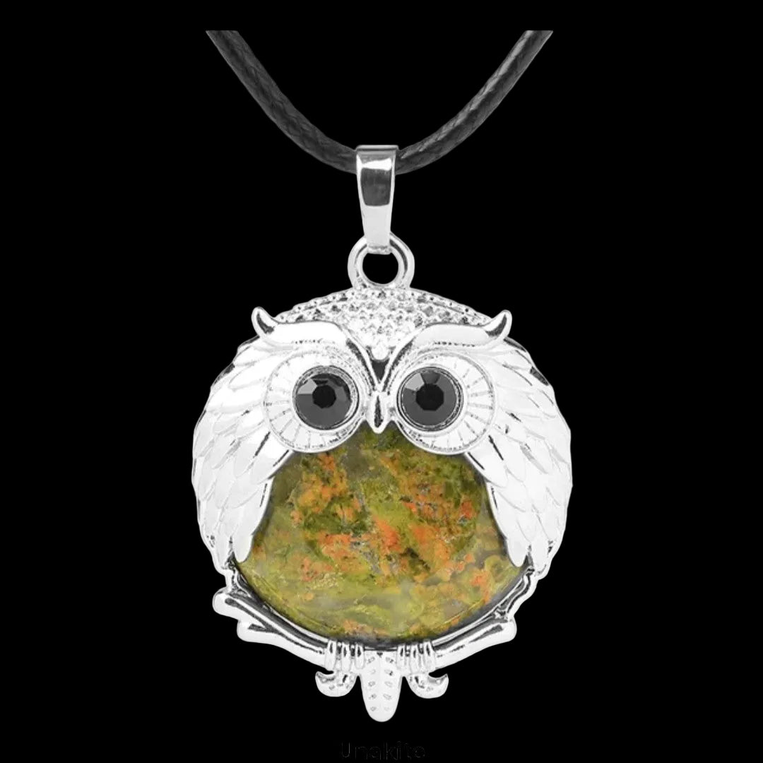Owl-shaped pendant with unakite stone on a black background